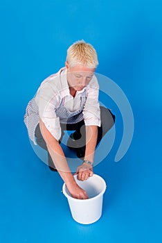 Woman with hand in bucket