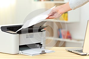Woman hand catching a document from a printer photo