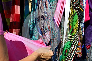 Woman hand choosing colorul  scarfs at indian market on India Days in Moscow