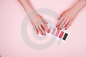 Woman hand choosing colour in color swatches