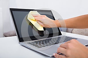 Woman Hand Cleaning Laptop Screen