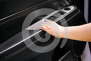 Woman hand closing car interior door