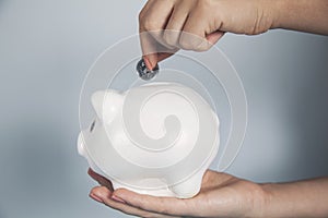 Woman hand coin with piggy bank