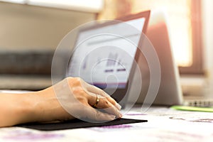 Woman hand on computer mouse notebook