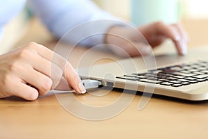 Woman hand connecting a pendrive in a laptop photo