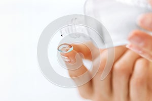 Woman Hand With Contact Eye Lens And Cleansing Solution