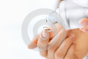 Woman Hand With Contact Eye Lens And Cleansing Solution