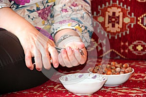 Woman hand cracking a walnut