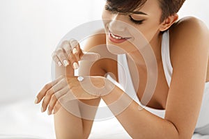 Woman Hand Cream. Close Up Of Beautiful Girl Applying Lotion