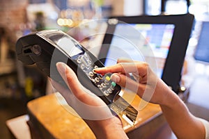 Woman hand with credit card swipe through terminal for sale