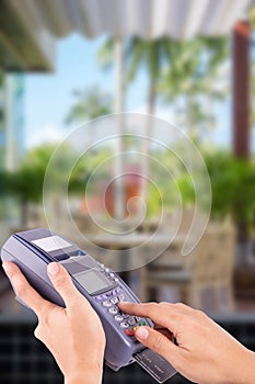 Woman hand with credit card swipe through terminal for sale