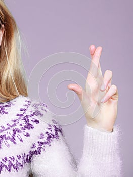 Woman hand crossing fingers, making promise gesture