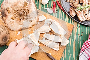 Woman hand cutting parasol mushrooms