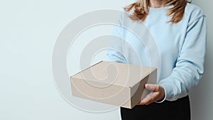 Woman hand with a delivery box on white background. Delivery concept. Delivery courier and shipping service concept