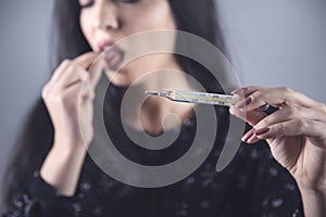 Woman hand drug and thermometer