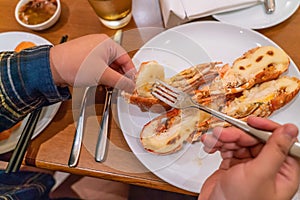 Woman hand eating Grilled Lobster