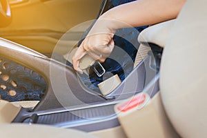 Woman hand fastens the seat belt ,Transportation and vehicle concept