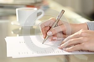 Woman hand filling out checkbox form at home photo