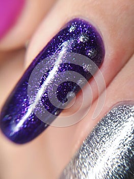 Woman hand finger violet purple silver metallic glitter manicure gel nail polish swatch design beauty macro photo