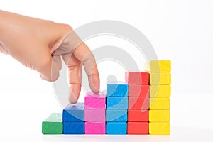 Woman hand finger walk on stacked wooden block like stairs. Business development and growth concept