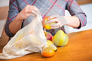 Woman hand getting out fruits after shopping from Eco bag. Anti-plastic bags. Zero Waste