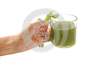 Woman hand give a healthy green vegetable juice