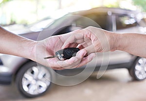 woman hand gives the car key