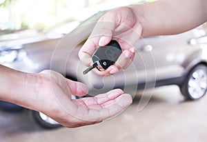 woman hand gives the car key