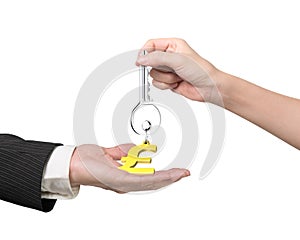 Woman hand giving key pound symbol keyring to man hand