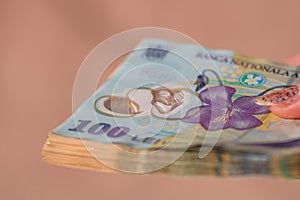 Woman hand giving money like bribe or tips isolated . LEI currency banknotes close up. Reward for hard work, finance and business