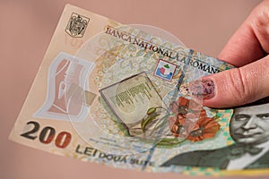 Woman hand giving money like bribe or tips isolated . LEI currency banknotes close up. Reward for hard work, finance and business