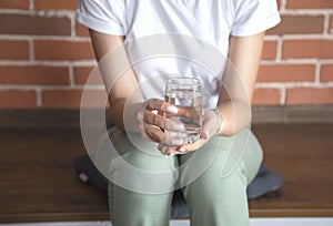 Woman hand glass of water