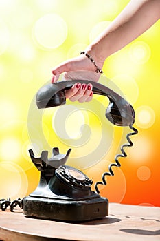 Woman hand hanging up the handset