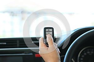 Woman hand hold a remote key car