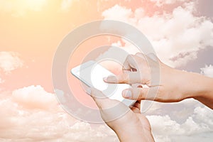 Woman hand hold and touch screen smart phone on cloud background