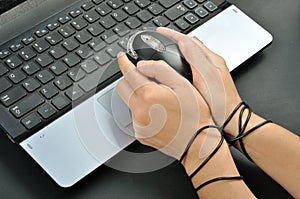 woman hand hold and were bond with computer mouse, internet addiction