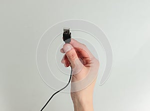 Woman hand holdin usb cable