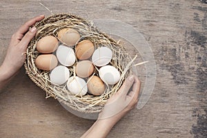 Woman hand holding basket in eggs.