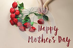 Woman hand holding a beautiful rose with happy mother`s day concept.