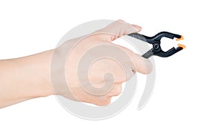 Woman hand holding black clamp, isolated with clipping path