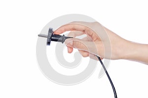 Woman hand holding black male wire plug on white