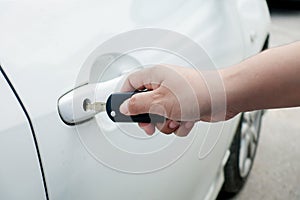 Woman hand holding car keys to unlock or lock