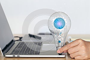 Woman hand holding cog inside in light bulb on white background, Creative idea and innovation concept