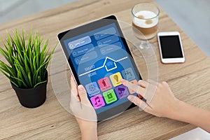 Woman hand holding computer tablet with app smart home screen