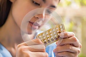 Woman hand holding a contraceptive panel