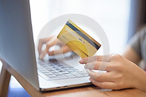 Woman hand is holding credit card, shopping online