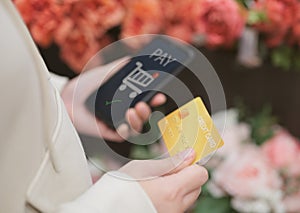 Woman hand holding credit card and using smartphone for online shopping. and are paying online successfully. digital banking, e-