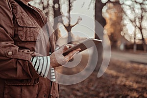 Woman hand holding digital tablet , reading news or watching online having video call using mobile application