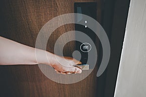 Woman Hand is Holding Door Handle While Opening a Door for Access Apartment Building. Electric Door With Keypad Code for Security 