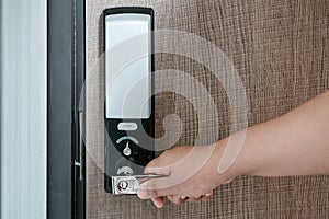 Woman Hand is Holding Door Handle While Opening a Door for Access Apartment Building. Electric Door With Keypad Code for Security